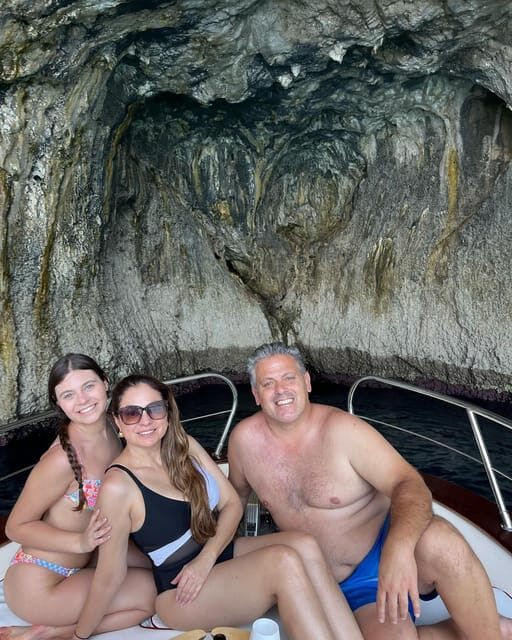 Capri: 2-hour boat tour of the caves and stacks - Passing under the faraglioni arch: the photo moment that sells the tour
