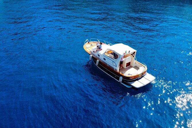 Luxury private boat tour to Capri and Blue Grotto on Gozzo 32 ft - Stop 5: I Faraglioni (Stella, Mezzo, Scopolo) up close