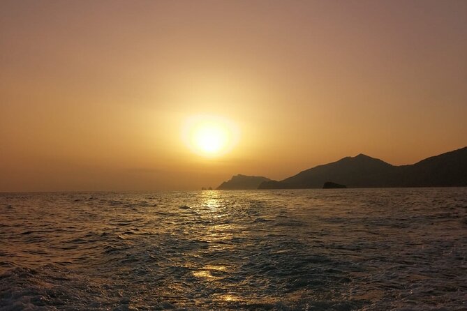 Private sunset boat tour on the Amalfi Coast and aperitif - Sunbeams, rocks, and how the scenery changes as night approaches