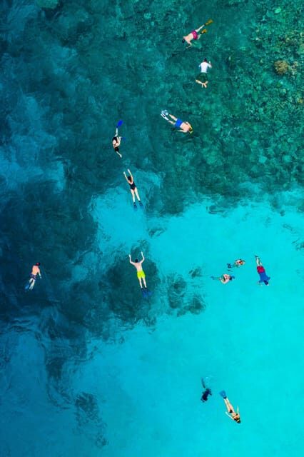 Sorrento: Capri and Blue Grotto Yacht Tour with Snorkeling - Faraglioni, Arco Naturale, and the coastline photo run